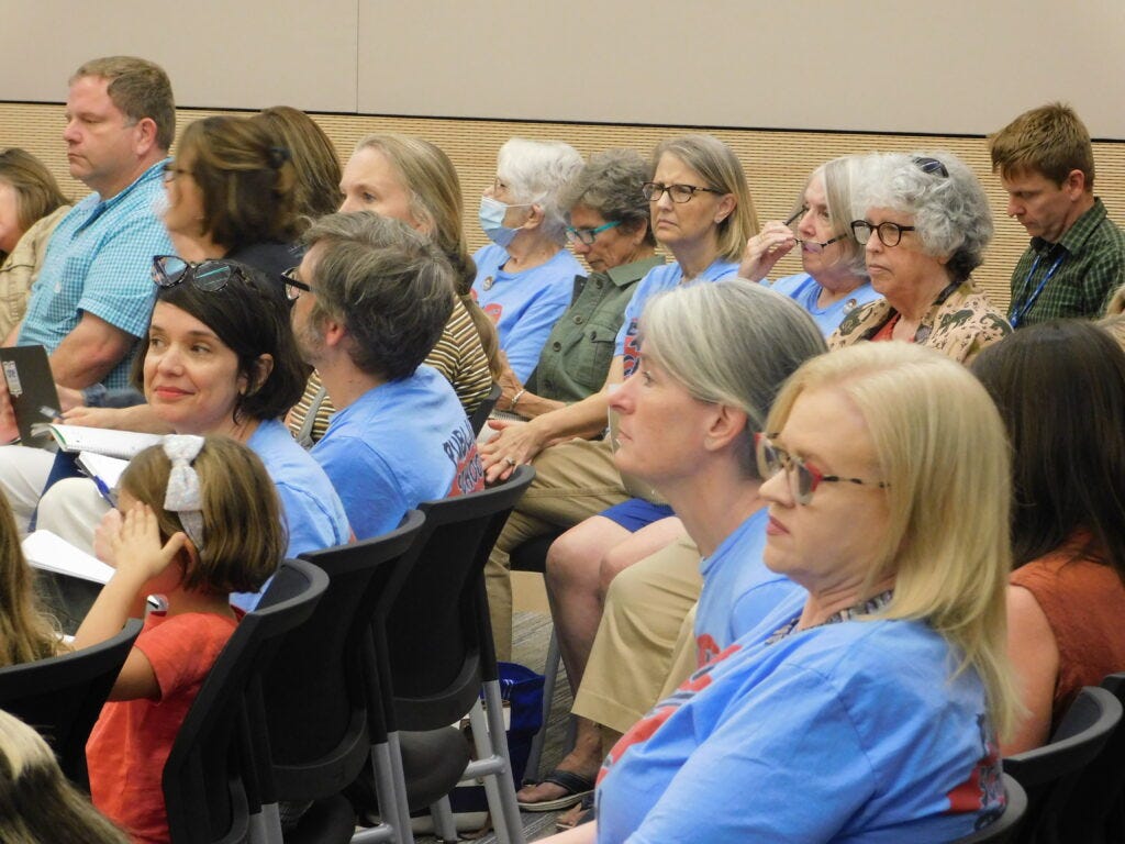 Public Strong School advocates listen during a Chatham County Board of Education meeting