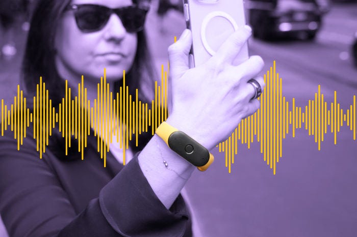 Woman wearing a yellow audio recording device, holding a smartphone.  Audio waves are overlaid.