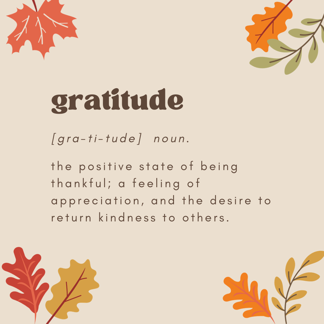 A definition of gratitude on a cream background with fall leaves