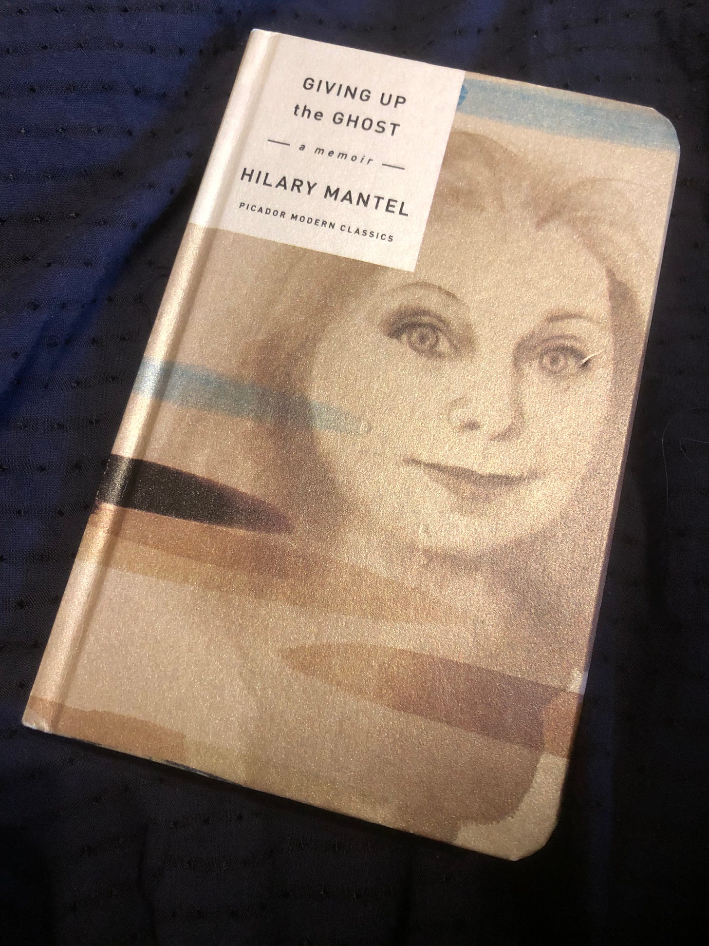 Giving Up the Ghost by Hilary Mantel, an edition that has a portrait of her on the cover