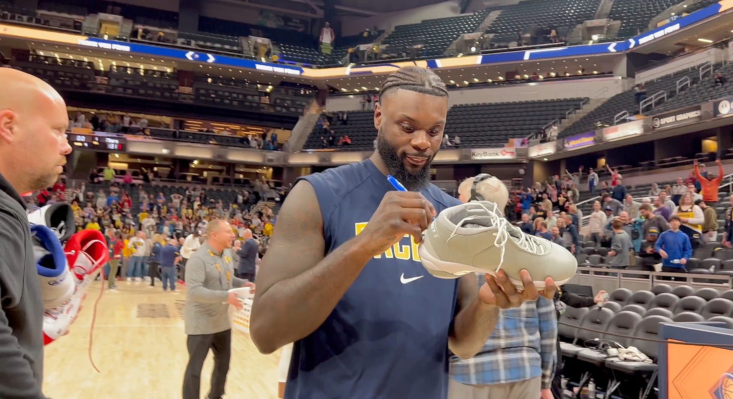 Lance Stephenson signs items for Pacers fans.