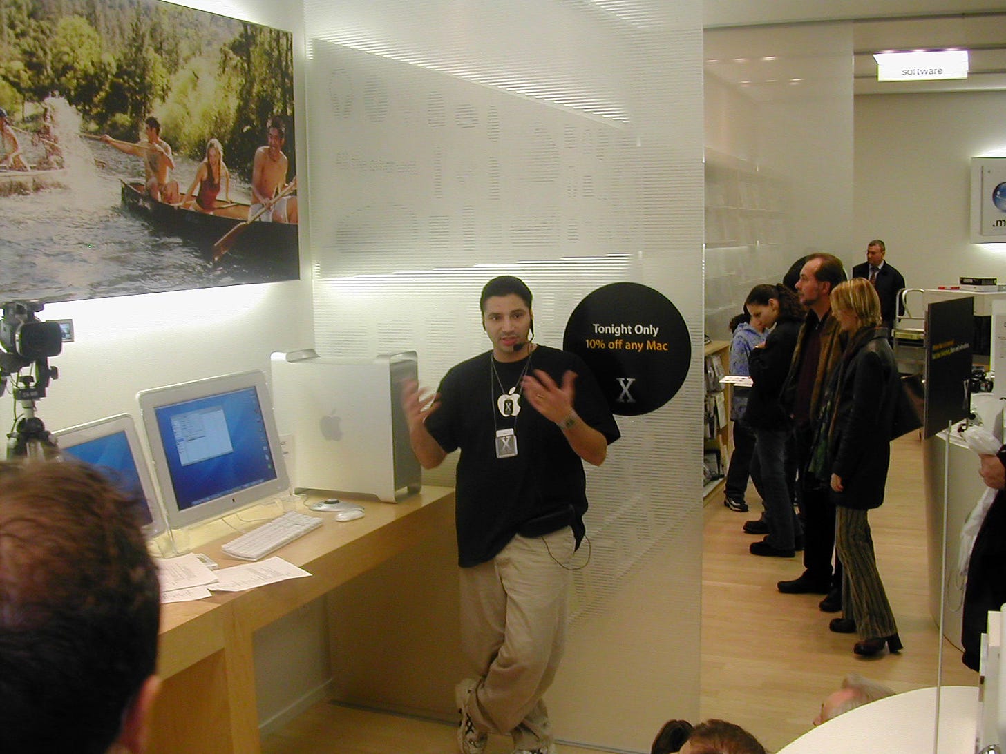 An Apple Store employee demonstrates Mac OS X during Night of the Panther.