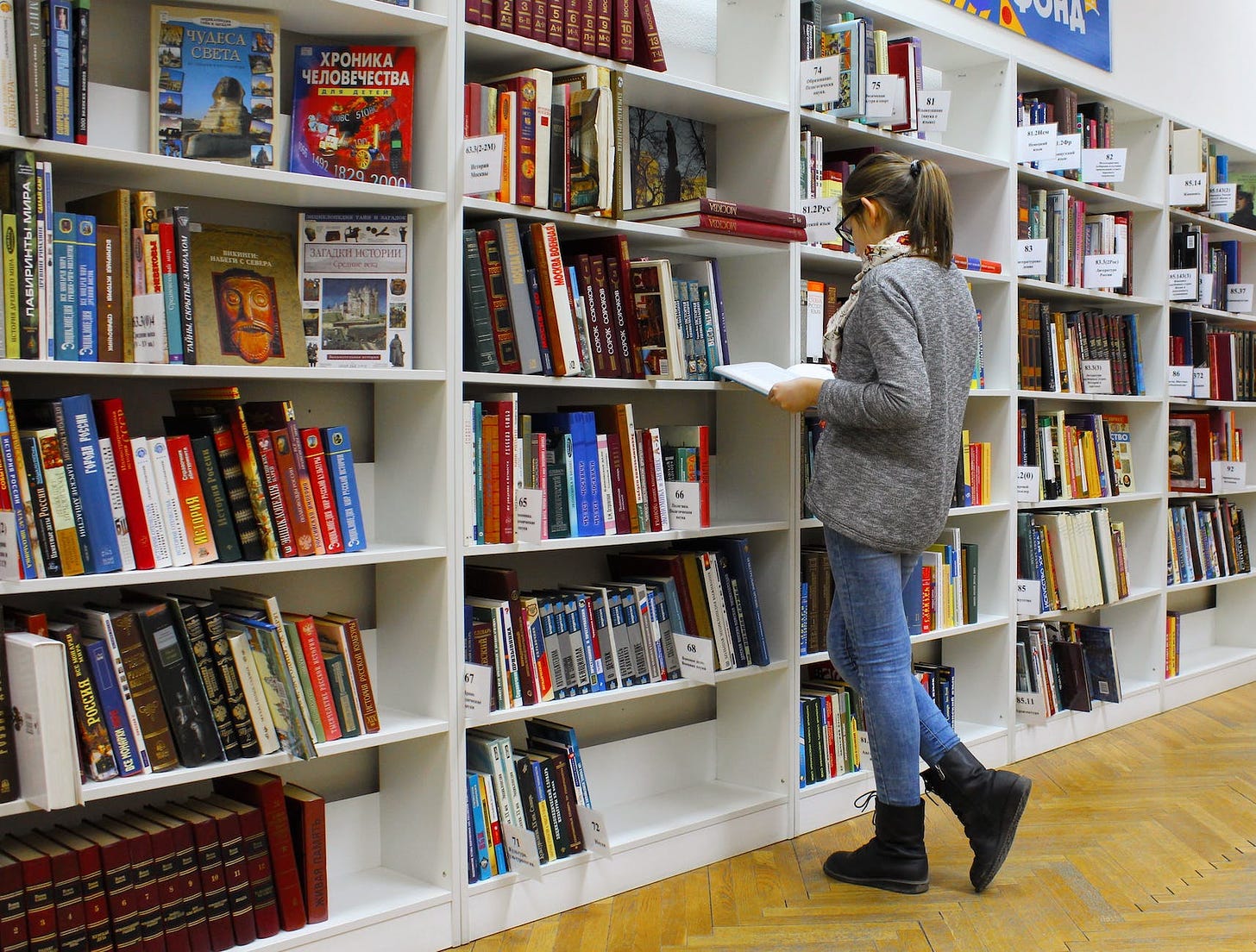 woman reading books so she can improve her self-esteem