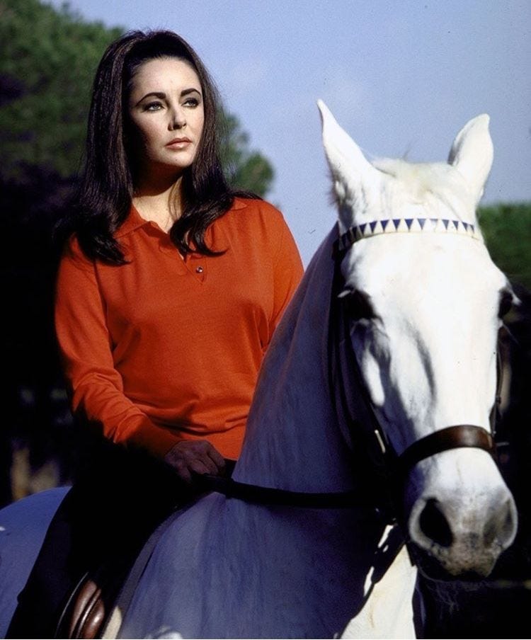 Elizabeth Taylor riding a white horse
