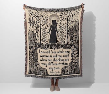 a blanket with an Audre Lorde quote and plants and a silhouette of a woman
