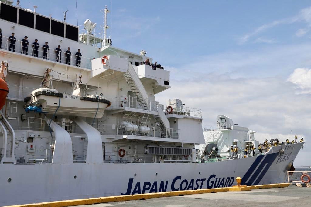 Japan Coast Guard ship Akitsushima docked at port.