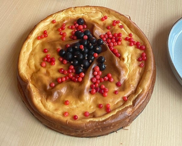 Cheese cake topped with currants and red huckleberries