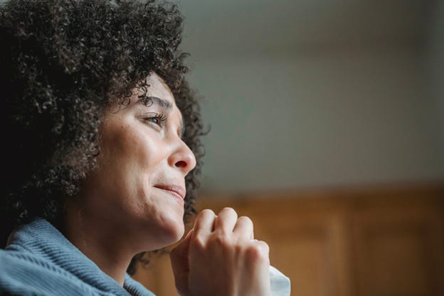 Young grief ethnic lady crying and looking away pensively Young grief ethnic lady crying and looking away pensively