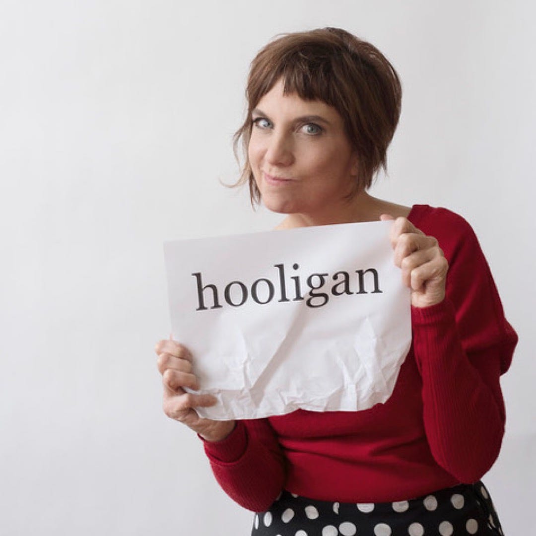 Nina Hart holding a sign that says “hooligan”