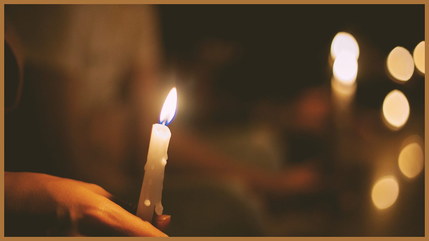 Hands holding a candle, which symbolizes the light of faith.