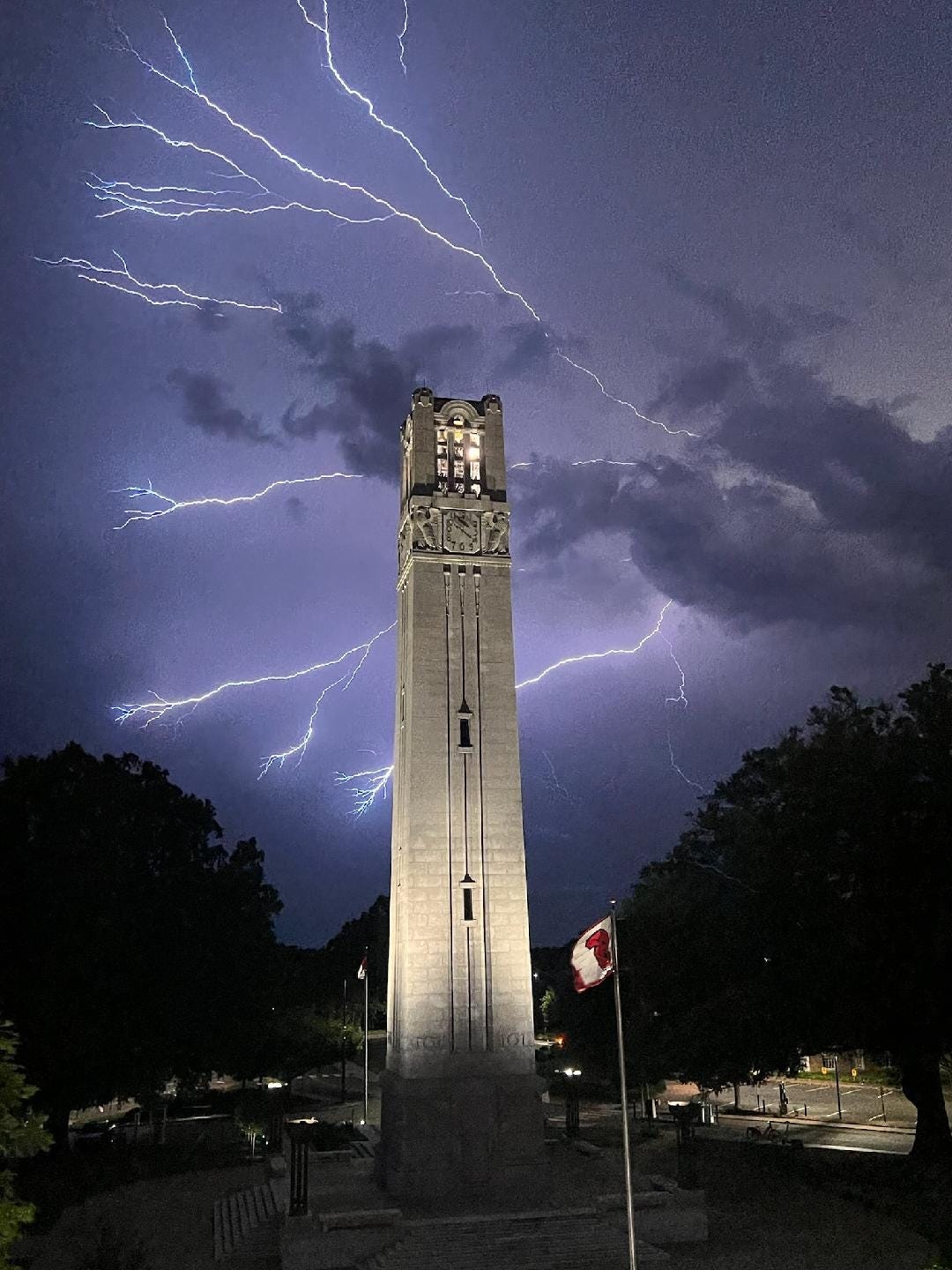 May be an image of bell tower, lightning and fireworks