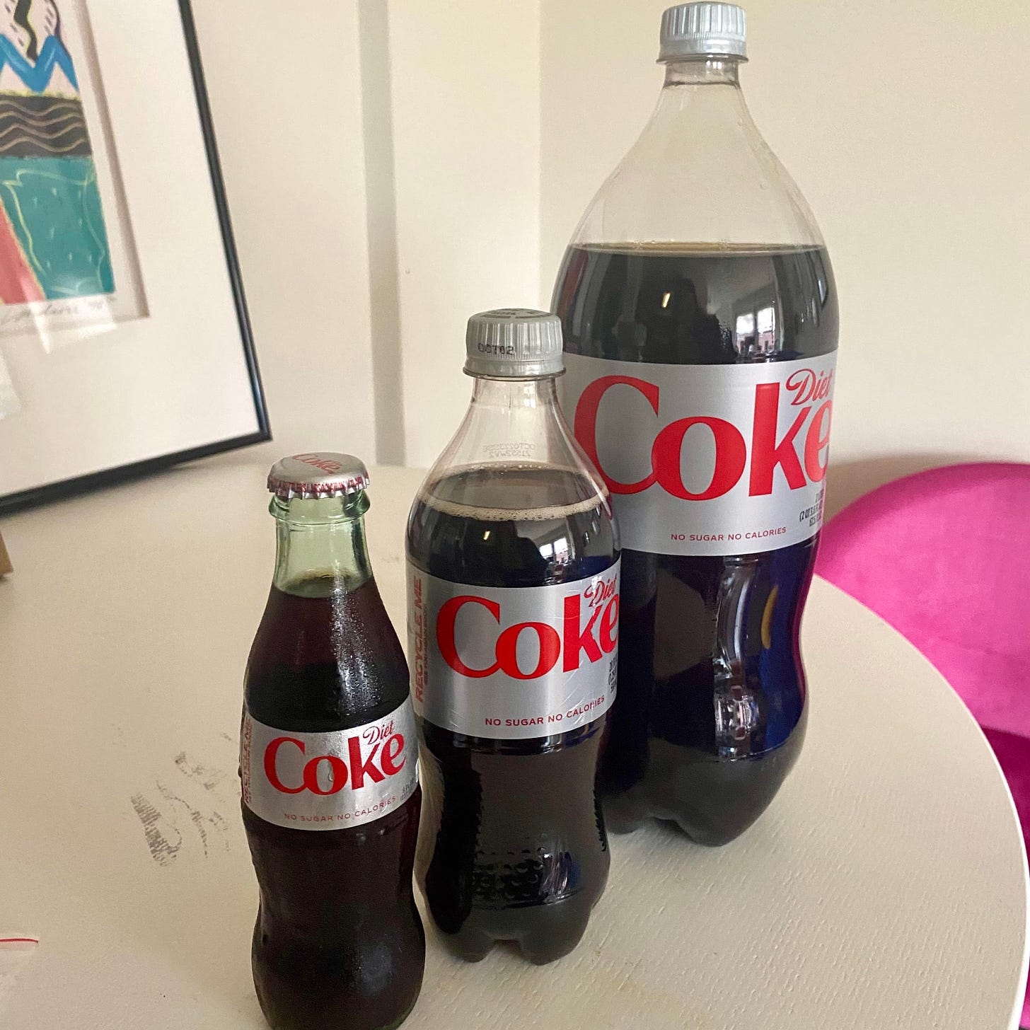Three Diet Cokes of varying sizes in harmony