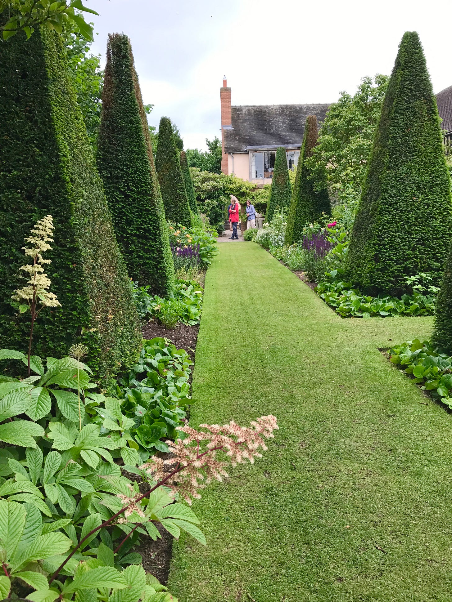 View down the Yew Walk back to the arched door
