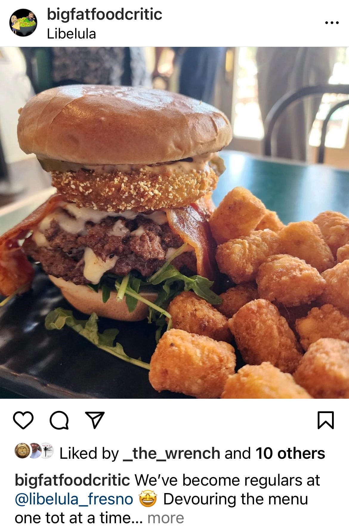 A burger from Libelula in Fresno California, surounded by tater tots