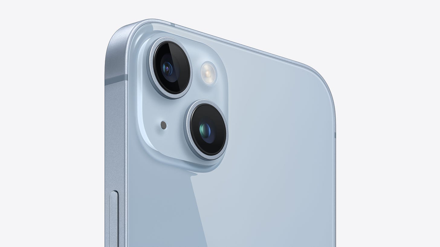 Angled close-up view of the dual-camera system on iPhone 14 Plus in blue.