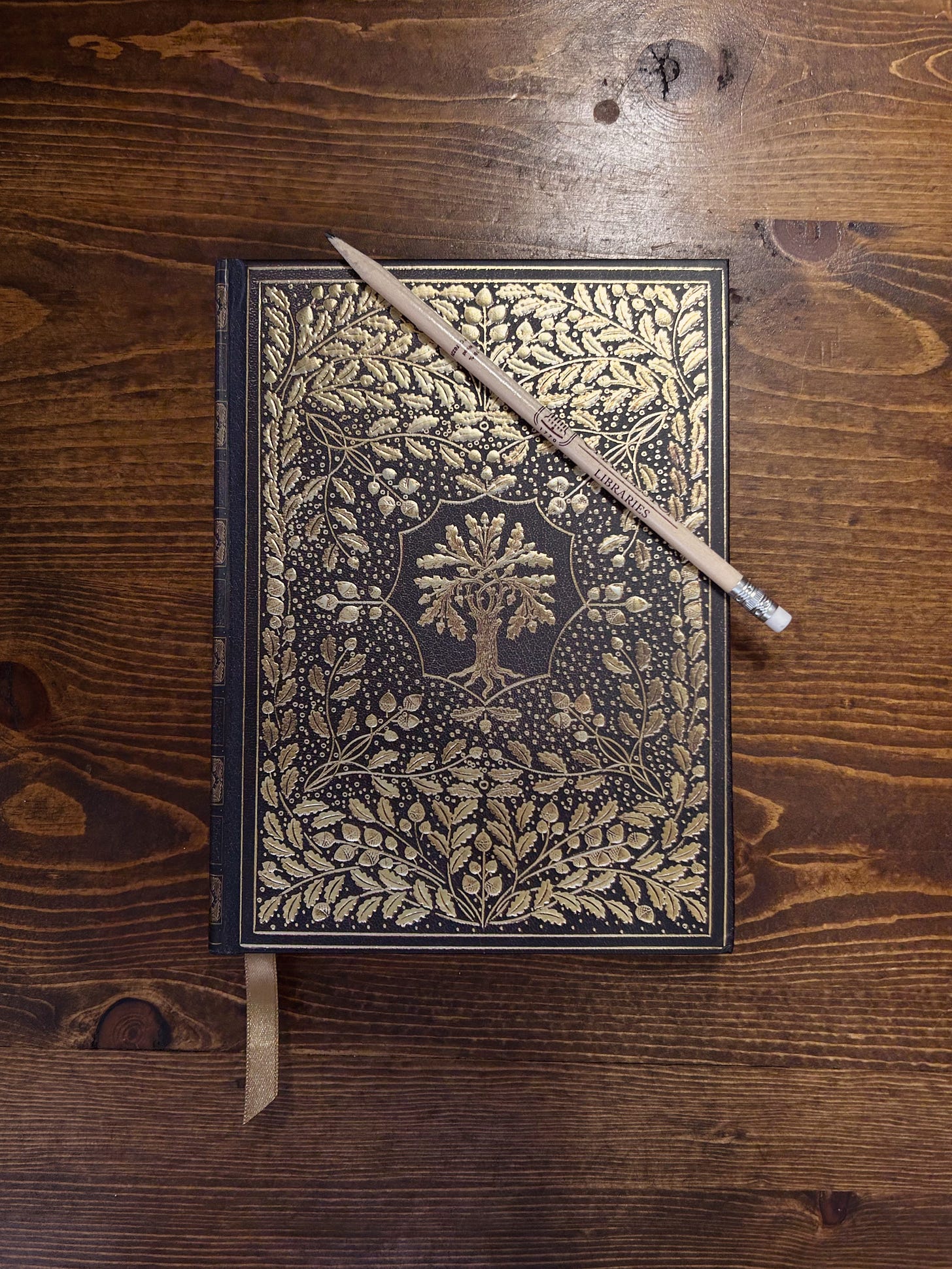 Vintage style journal with gold oak tree and leaves and natural wood pencil.