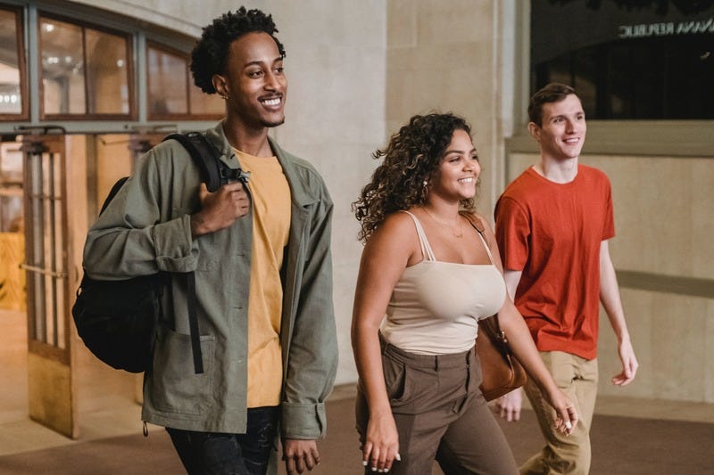 Three people smiling and walking together