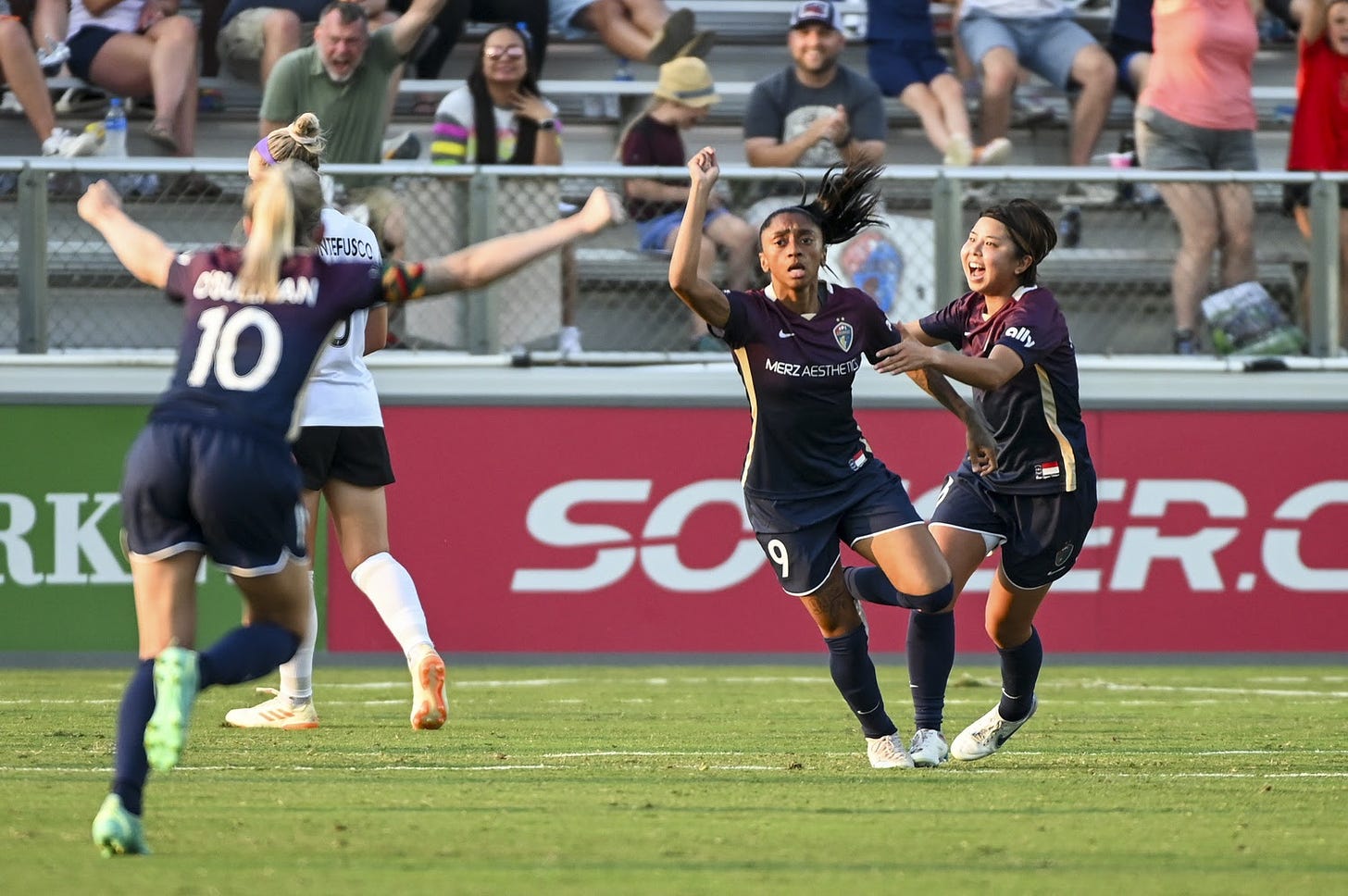 Kerolin celebrates with NC Courage teammates after a goal.