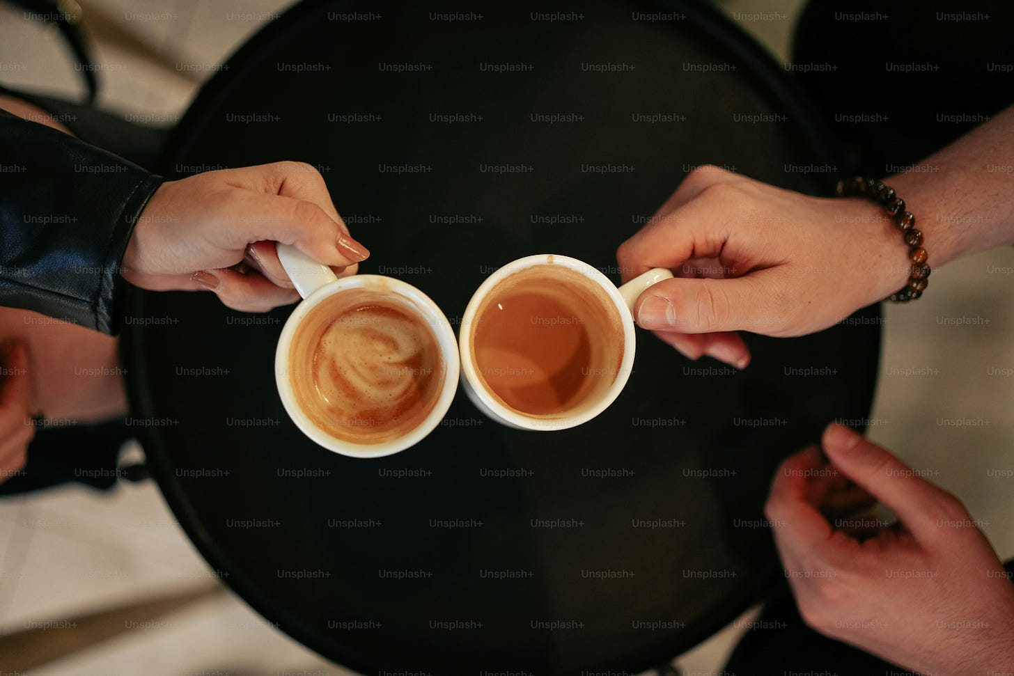 a couple of people holding cups of coffee