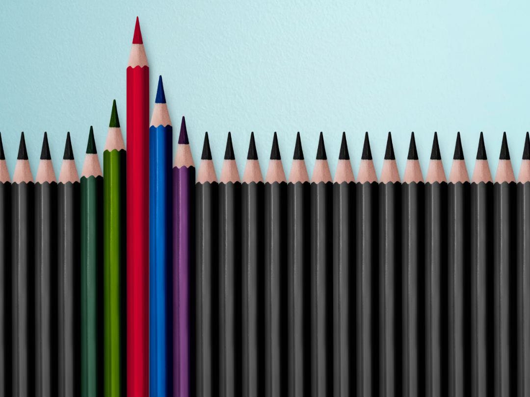 Photo of about twenty sharpened pencils, most the same color at the same level, but a few with different colors, rising higher than the rest.