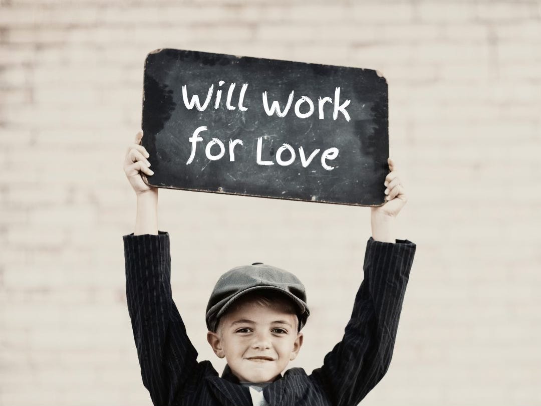 Photo of a boy holding up a small chalkboard. On the board is written the words, "Will work for love."