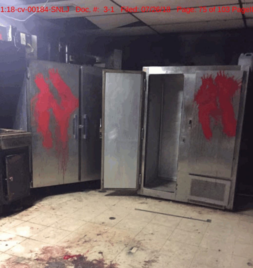 A piece of photo evidence from the Department of Labor affidavit depicting red paint splatter on the doors of what look like industrial cabinets in the former Dunklin County Jail.