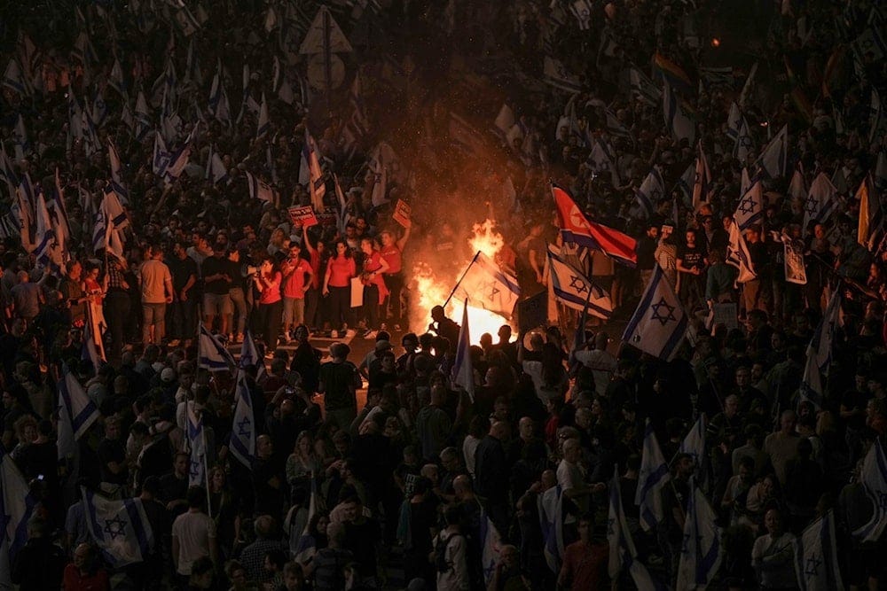 Israelis light a bonfire during a protest after Prime Minister Benjamin Netanyahu has dismissed his popular minister Yoav Gallant, in Tel Aviv, Tuesday, Nov. 5, 2024. (AP)