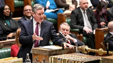 Reuters Sir Keir Starmer, dressed in a dark suit, stands at the despatch box in the House of Commons in February 2024