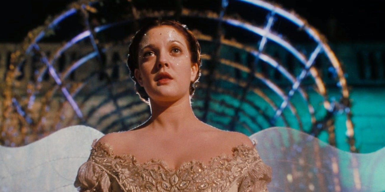 Image from Ever After of Drew Barrymore looking past the camera wearing a dress with wings.