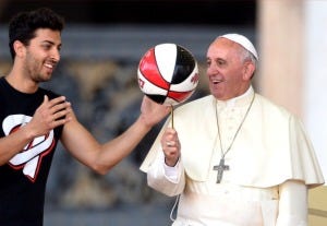 Pope Francis plays with a basketball during the Italian Catholic Sports Centre (CSI) 70th anniversary celebrations, on June 7, 2014, in St Peter's Square, at the Vatican. (credit: ALBERTO PIZZOLI/AFP/Getty Images)
