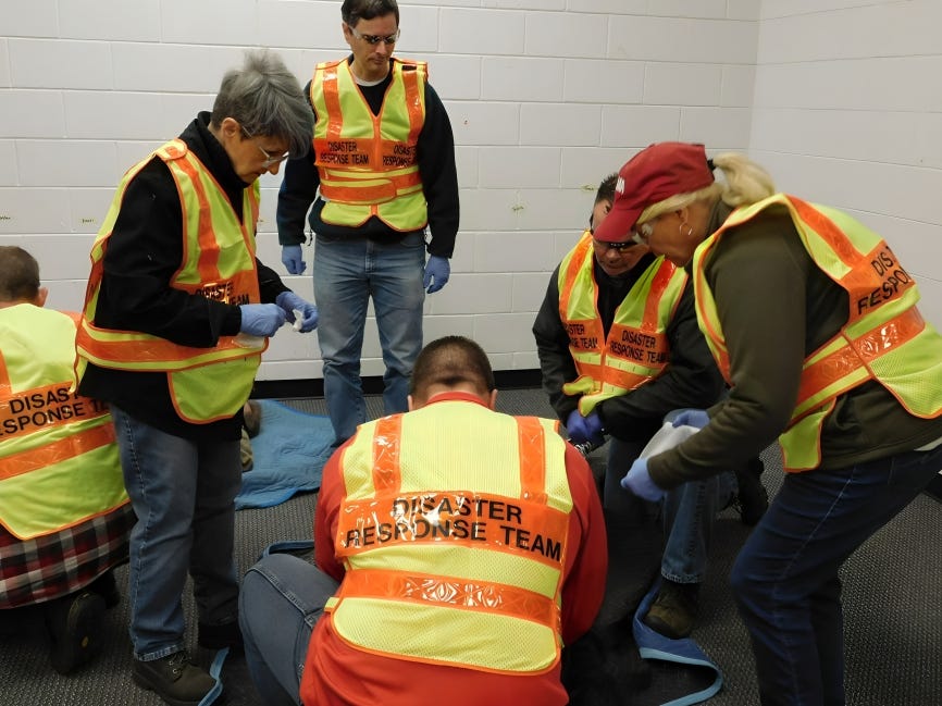 Volunteer disaster response team members in uniform, ready to assist in an emergency as part of their commitment to community preparedness.