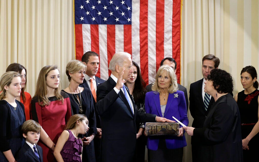 File: Then-US Vice President Joe Biden, with his wife Jill Biden holding the Biden Family Bible, takes the official oath of office from Supreme Court Justice Sonia Sotomayor, surrounded by family, during an official ceremony at the Naval Observatory, January 20, 2013, in Washington. (AP Photo/Carolyn Kaster)