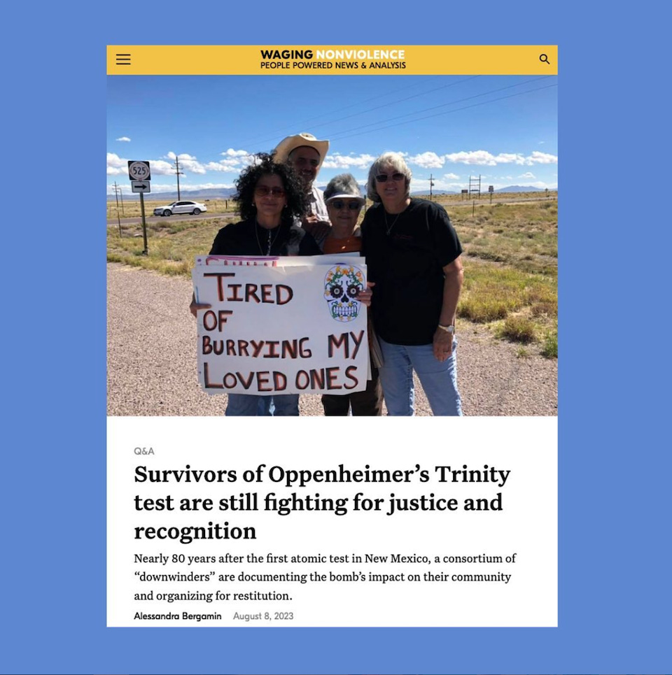a screenshot of an instagram post against a blue background. the instagram post shows a photo of a four people standing outdoors, one is holding a sign that reads 'Tired of Burying my loved ones'