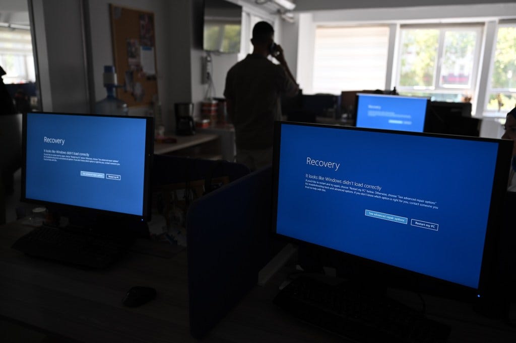 In this photo illustration the blue screen of death errors on computer screens are viewed due to the global communications outage caused by CrowdStrike