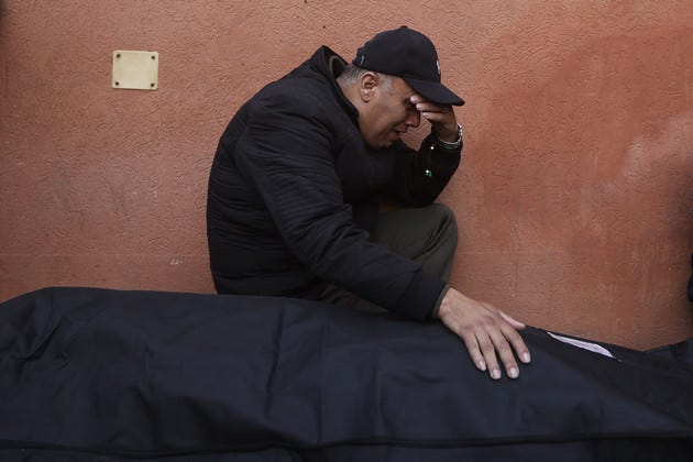 A Palestinian man mourns a relative killed in the Israeli bombardment of the Gaza Strip outside a morgue. A Palestinian man mourns a relative killed in the Israeli bombardment of the Gaza Strip outside a morgue.