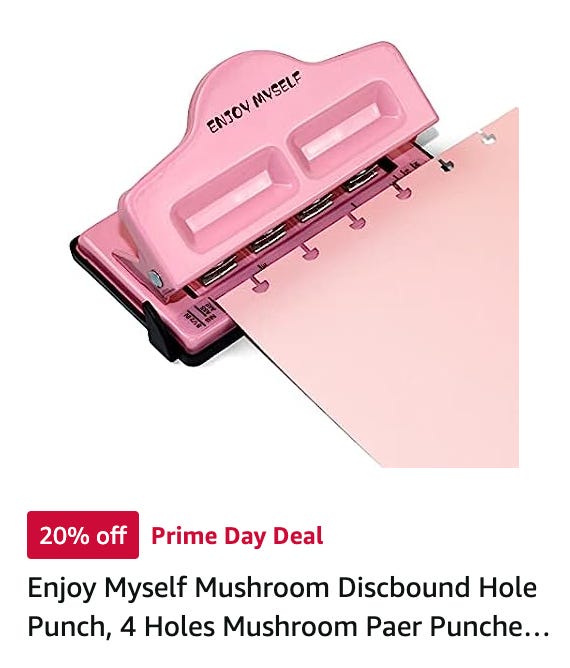 A pink hole punch that says "Enjoy Myself" on it. It's called a "mushroom" hole puncher because instead of just holes, it punches a mushroom, leaving the pages removable.