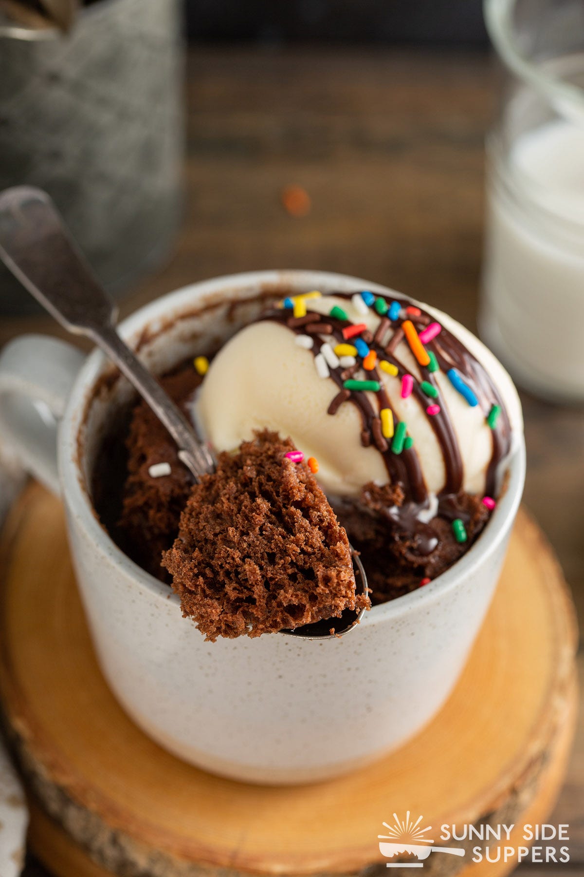 Chocolate mug cake with a spoon taking out a scoop.