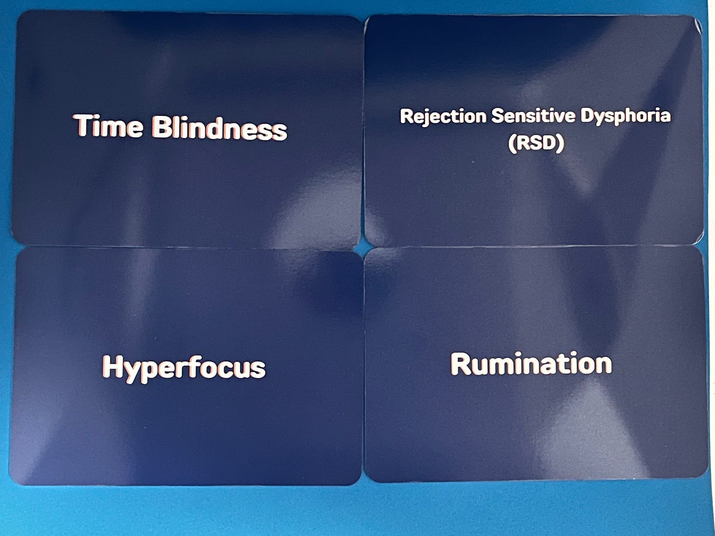 4 cards each titled: Time Blindness, Rejection Sensitive Dysphoria, Hyperfocus, and Rumination