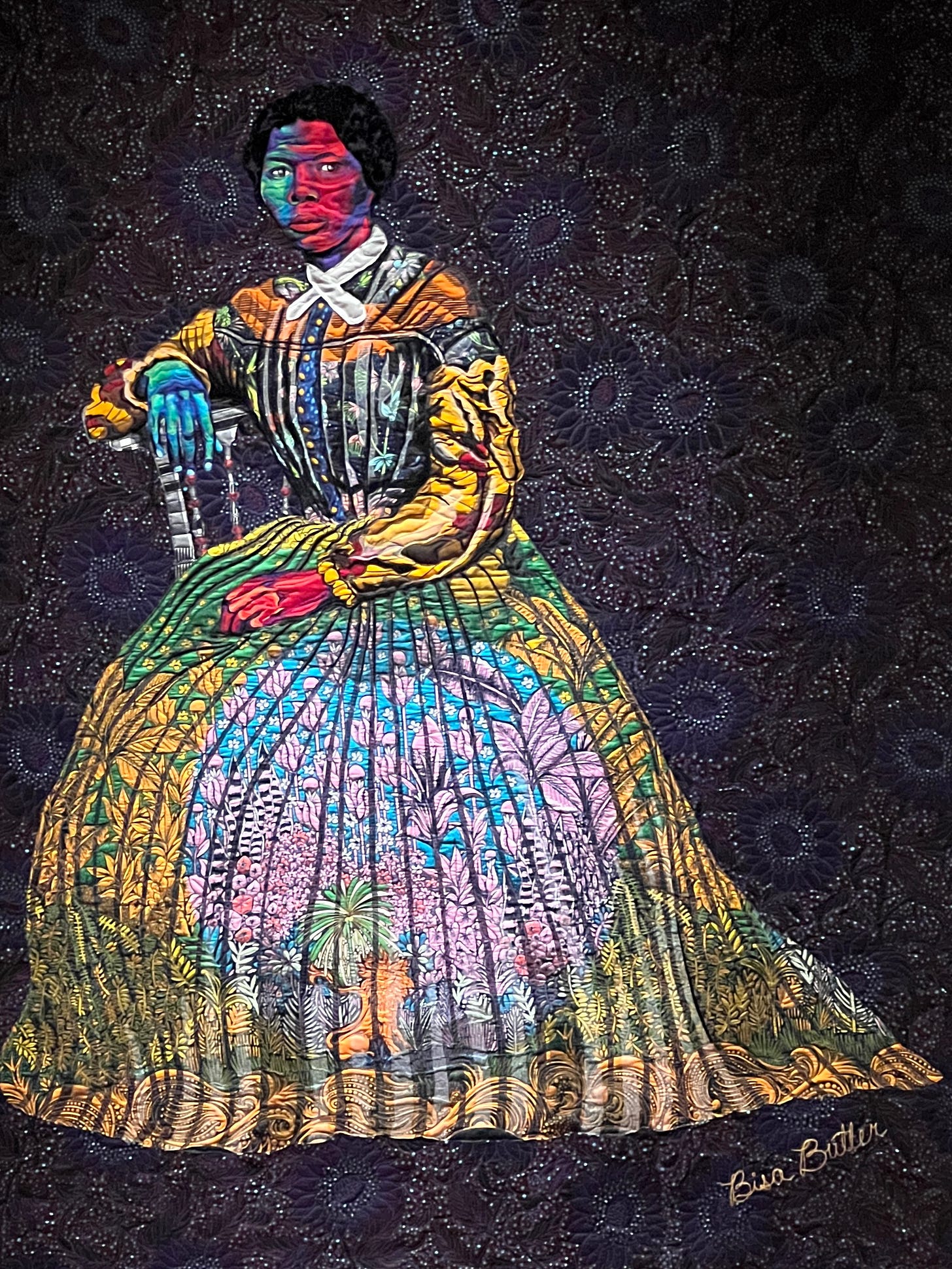 An image of Harriet Tubman shown in brightly colored quilted material.