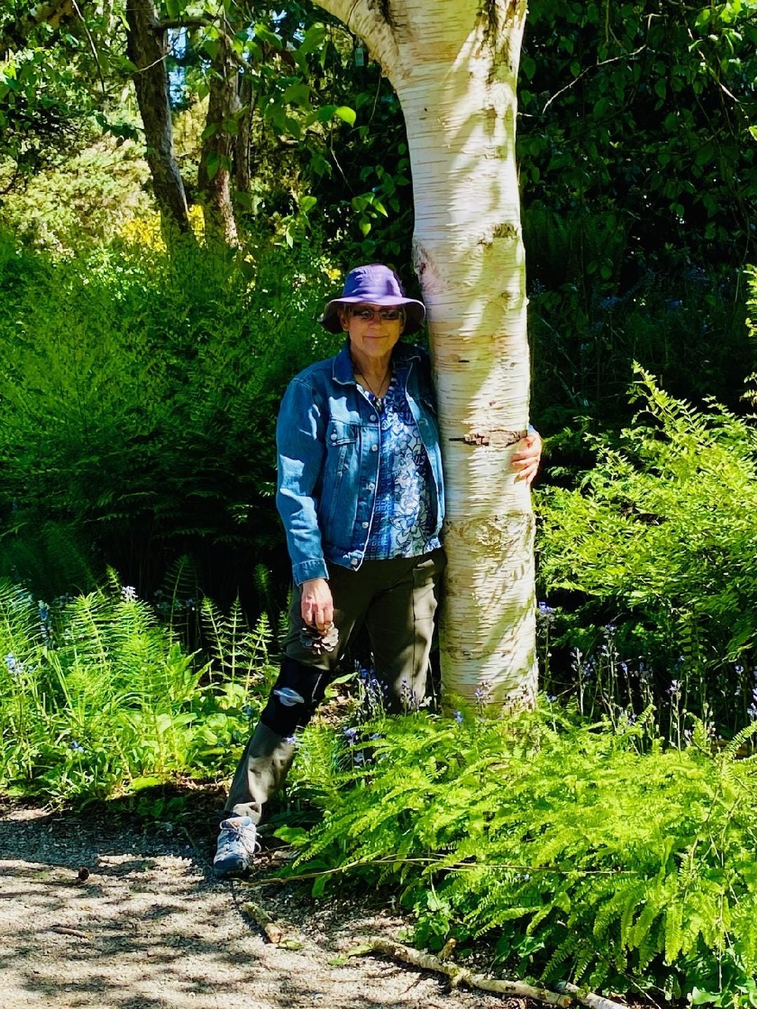 Picture of Robin standing next to tree in the Van Dusen Botanical Gardens (Vancouver, BC) May 2024