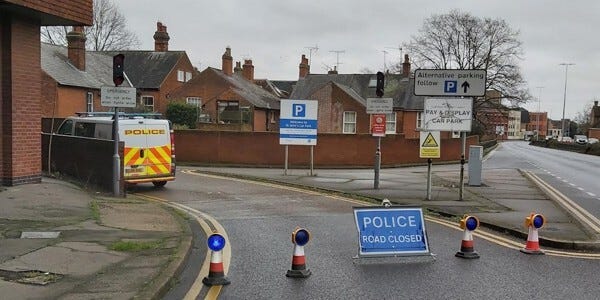 Police 'road closed' sign at entrance to a car park in Colchester