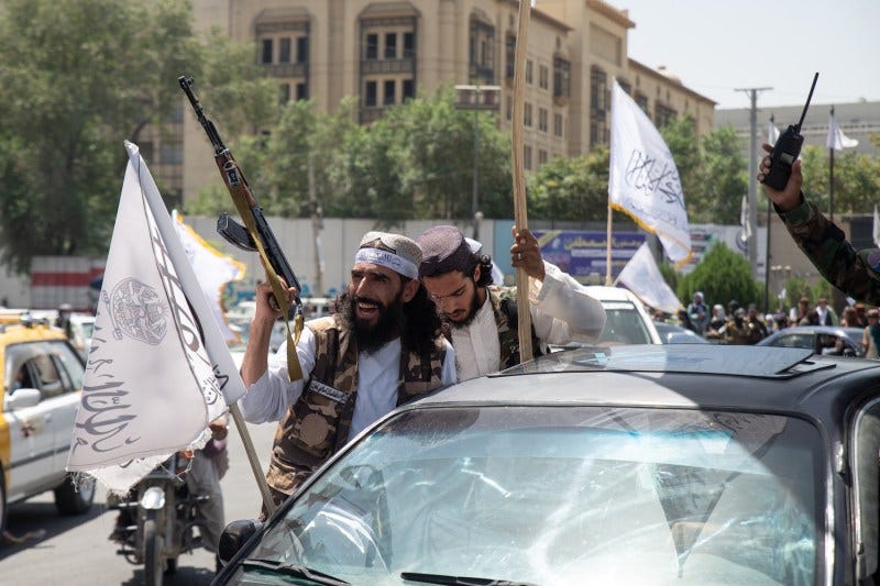 Taliban supporters parade through the streets of Kabul.