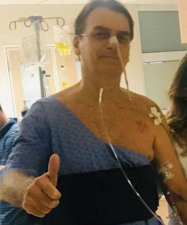 Jair Bolsonaro in the hospital giving a thumbs up