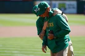 Vietti] This is a powerful photo of A's head groundskeeper Clay Wood being  consoled as he prepares the field at the Oakland Coliseum one last time.  This was Clay's 31st and final