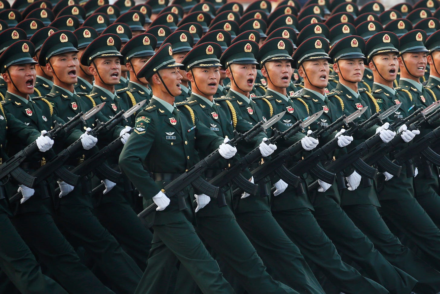 Soldiers of People's Liberation Army (PLA) march in formation past Tiananmen Square during a rehearsal before a military parade marking the 70th founding anniversary of People's Republic of China