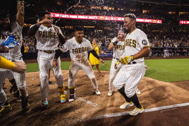 Xander Bogaerts of the San Diego Padres celebrates after hitting a walk-off home run in the ninth inning against the Colorado Rockies on September...