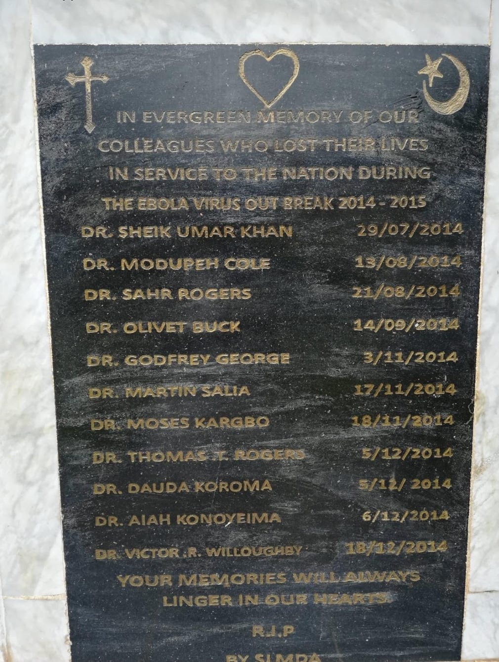 a picture of a stone memorial carved with the names of health professionals who lost their lives fighting the Ebola epidemic in Sierra Leone from 2014-2015