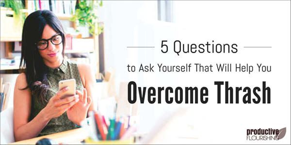 Woman wearing glasses looking at phone in office setting at desk. Text overlay: 5 Questions to Ask Yourself That Will Help You Overcome Thrash