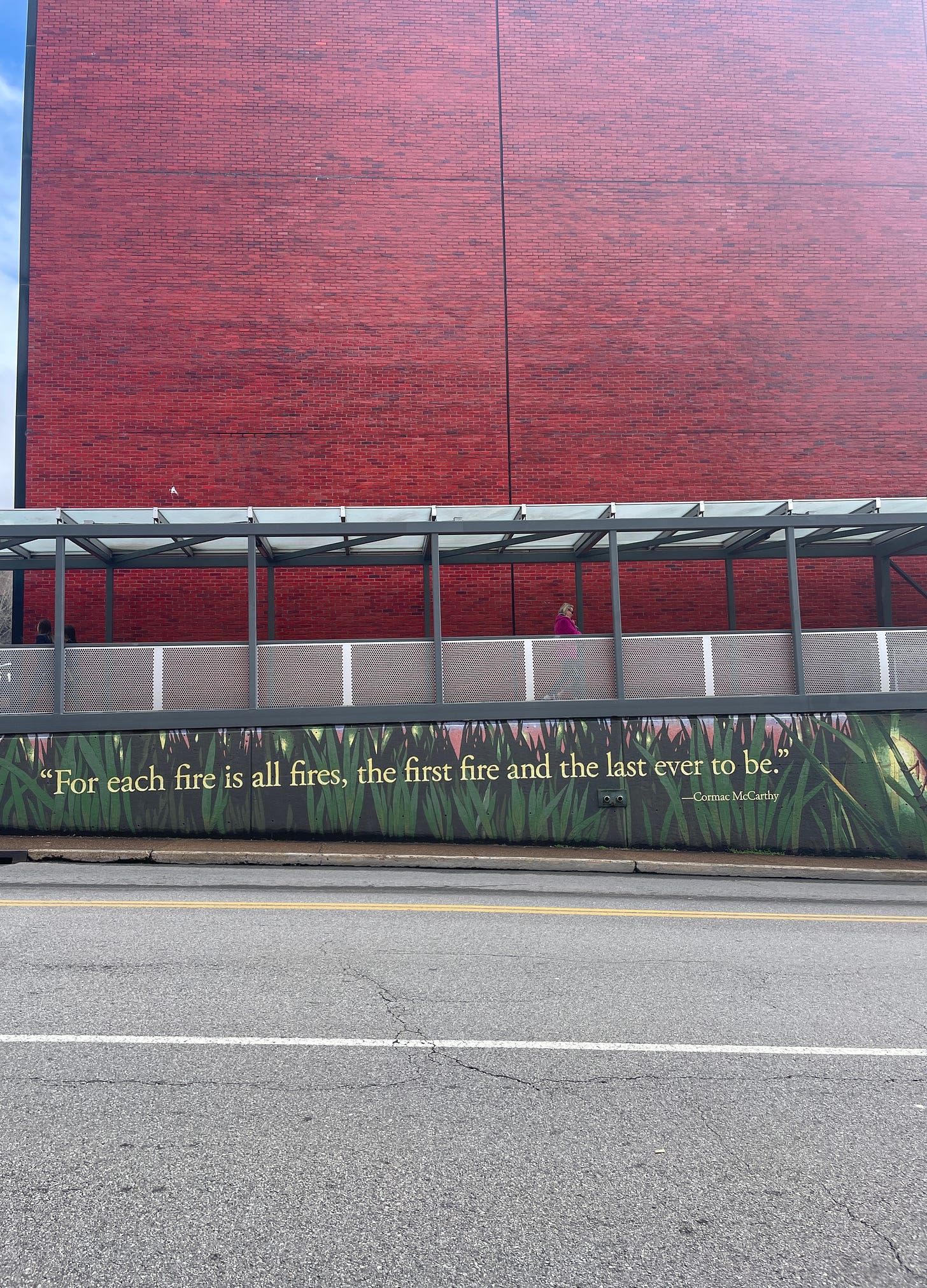 Mural with the quote "For each fire is all fires, the first fire and the last ever to be" by Cormac McCarthy