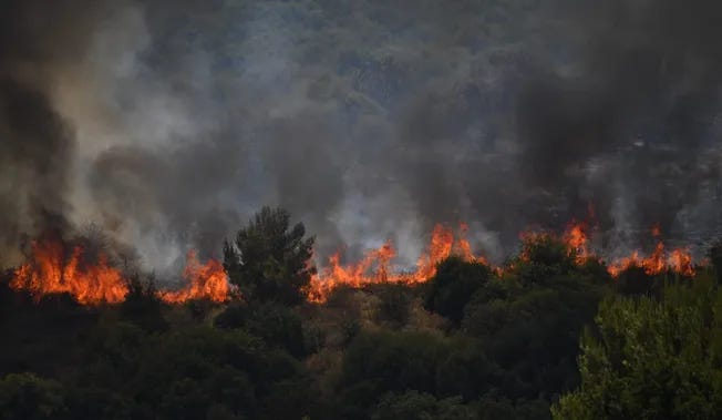 Fire ignited in northern Israel following a hit by a rocket launched from Lebanon, on Wednesday.